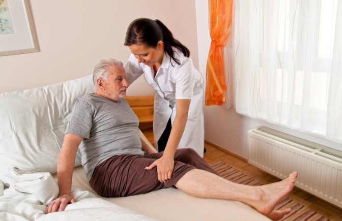 caregiver helping the elder man